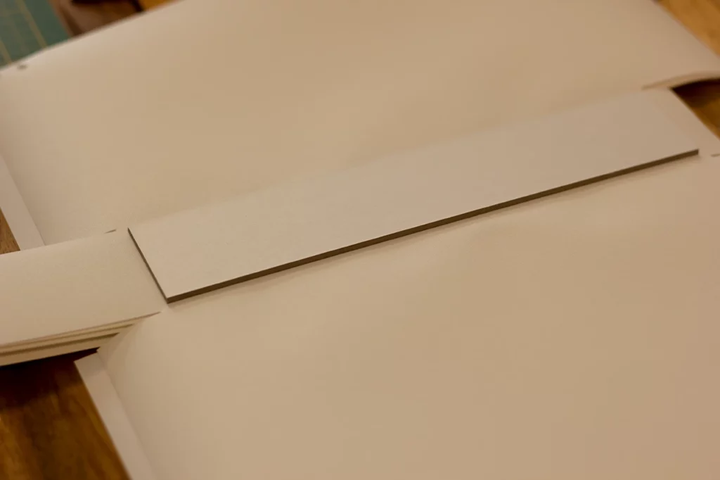 Dos recouvert d’une toile de reliure blanche pour le prototype de porte-revues.